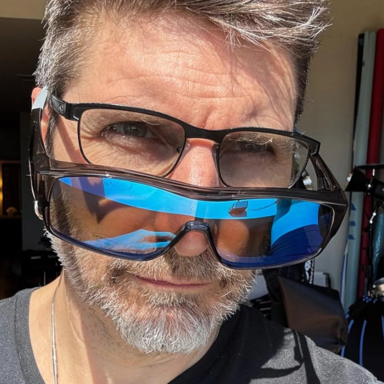 Person wearing reflective sunglasses in an indoor setting